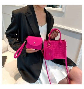 Detailed set of magenta faux leather bags with crocodile texture and gold hardware details