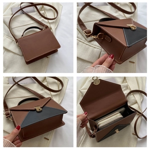 Detail view of contrast color crossbody bag with gold lock and adjustable strap