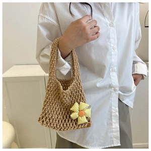 Detail of hand-woven cotton net bag featuring a yellow checkered floral charm