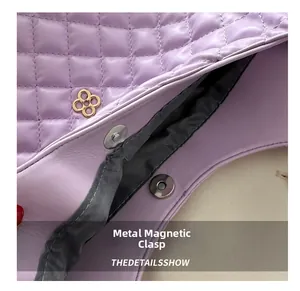 Detail of lavender quilted tote bag with gold floral hardware and magnetic closure