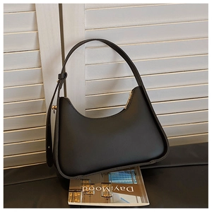 Detailed view of black matte leather underarm bag with adjustable metal buckle strap