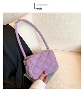 Detail of purple quilted nylon shoulder bag with soft padding and rhombus pattern