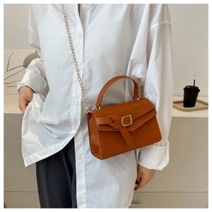 Close-up of brown PU leather handbag featuring a twist knot strap and gold metal buckle