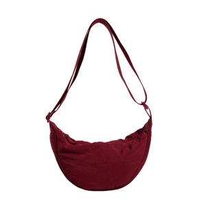 Large burgundy nylon crescent crossbody bag with adjustable strap and top zipper closure