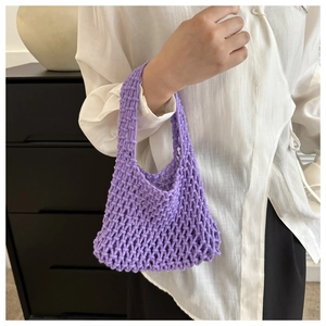 Detailed view of purple hand-woven mesh wrist bag with thick knit texture and hollow design