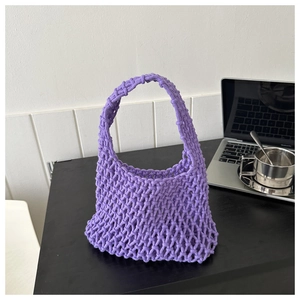 Close-up of purple handmade woven net bucket bag showing hollow cotton rope texture