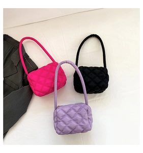 Detail of quilted nylon puffer handbags in pink, black and lilac with cloud texture