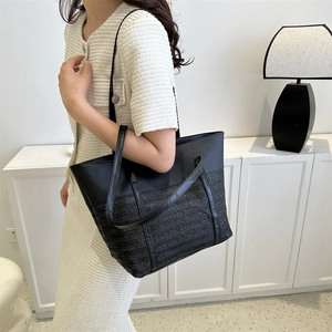 Fashionable black woven tote bag with leather handles and large capacity shoulder design