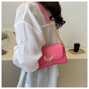 Detailed hot pink faux-crocodile shoulder bag featuring a gold crescent moon buckle and chain