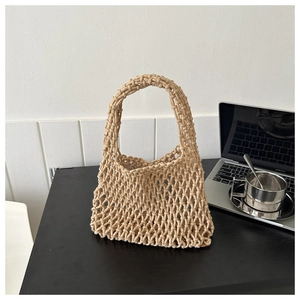 Close-up of handmade beige cotton rope weave detail on a bohemian style bucket bag