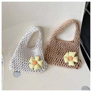 Detail of hand-woven mesh tote bags with gingham flower accents in beige and tan colors