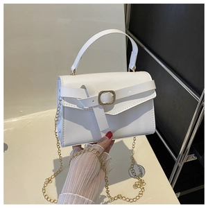 Detail of white PU leather handbag featuring gold metal buckle and elegant chain strap