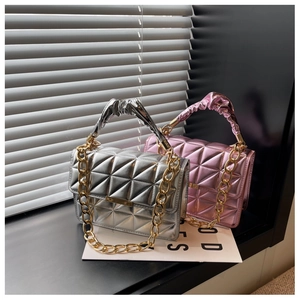 Detail of silver and pink quilted handbags with gold chain straps and pleated handles