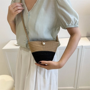 Handmade woven flower straw handbag with two-tone design and pearl clasp for summer