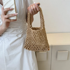 Handmade woven cotton mesh bucket bag in beige, perfect for summer beach vacations
