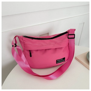 Detailed close-up of rose red nylon half-moon crossbody bag with adjustable strap