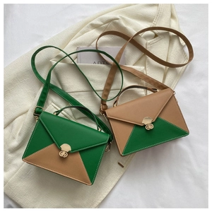 Detail of color-block envelope handbags with gold locks and detachable straps