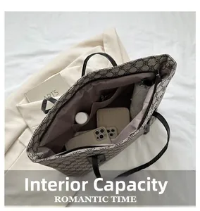 Interior view of monogram tote bag showing large capacity for phone and umbrella