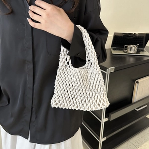 Handcrafted white cotton mesh wrist bag with hollow weave design for beach holidays