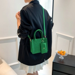 Green crocodile embossed handbag with crossbody strap and matching mini coin purse