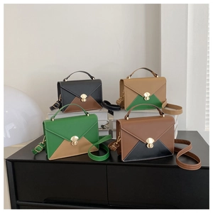 Detailed display of envelope patchwork handbags in four colorways with gold lock buckles