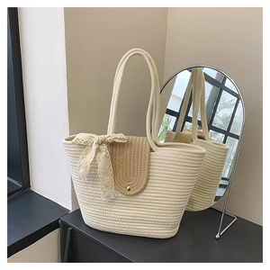 Close-up of woven cotton rope tote bag with brown lid and lace bow detail