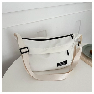 Detail shot of white Oxford cloth bag with NUOYANG logo and wide adjustable shoulder strap