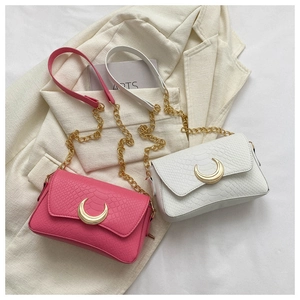 Detail of pink and white faux crocodile bags with golden crescent locks and chain straps
