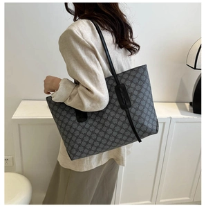 Detailed view of the large capacity tote bag with letter print worn in a modern room