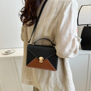 Minimalist color-block flap handbag with caramel and black leather and gold clasp