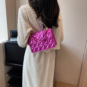 Chic magenta quilted crossbody bag with metallic finish and chunky gold chain strap