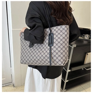 Lifestyle shot of large capacity tote bag with grey geometric pattern and leather straps