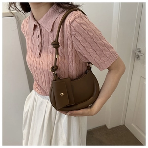 Brown hobo underarm bag with small pouch and knotted strap shown on female model