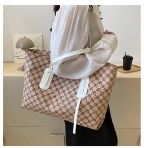 Close-up of a large tote bag with retro geometric pattern and white leather straps