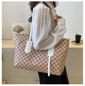 Detailed side view of large capacity tote bag with brown geometric floral pattern