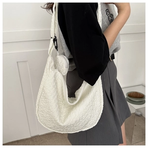 Detail of white pleated texture fabric crossbody bag with matching round coin pouch set