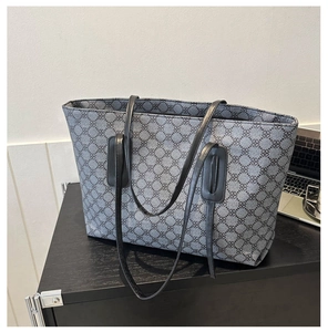 Detail of grey large capacity tote bag with vintage clover print and slim black straps