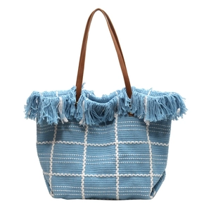 Blue and white checkered woven tote bag with fringe details and brown leather handles