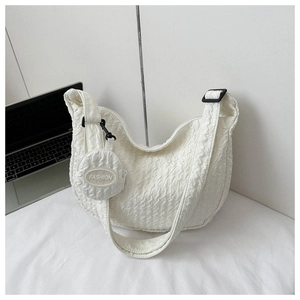 Detail of white quilted hobo bag with cloud texture and small round fashion coin purse