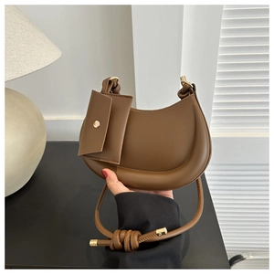 Brown half-moon shoulder bag with detachable mini envelope card pouch and leather knot detail