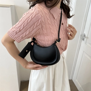 Chic black faux leather half-moon shoulder bag with a matching small accessory pouch