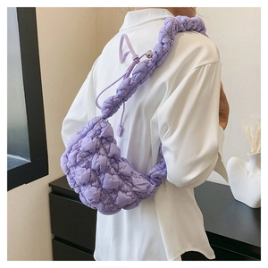 Detail of purple ruched cloud bag with adjustable silver ball buckle and quilted texture