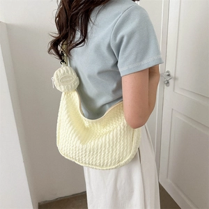 Quilted light yellow hobo bag with a fashion coin purse shown on a model