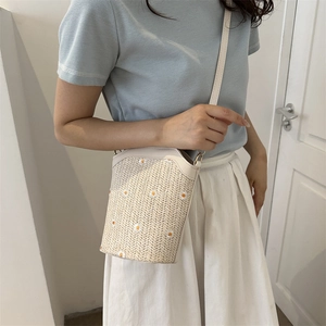 Summer straw crossbody bucket bag with white daisy embroidery and leather strap