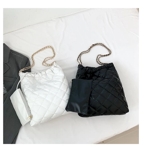 Détail de sacs cabas matelassés avec chaînes dorées et mini-pochettes assorties