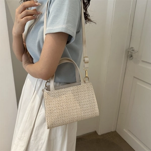 Minimalist straw woven crossbody bag for women with leather trim for summer beach vacation