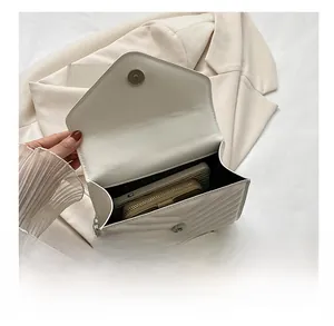 Internal capacity of the white V-quilted envelope bag with silver chain strap