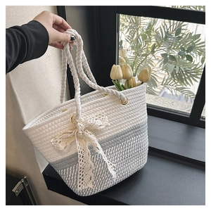 Détail du sac seau en corde tressée avec nœud en dentelle et poignées en coton robustes