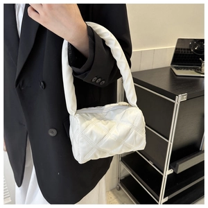 Detail of white quilted nylon mini bag with rhombus stitching and zipper closure
