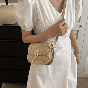 Women's woven crossbody bag with pink floral embroidery and golden metal clasp details